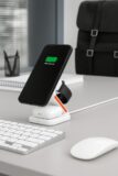 AIRIX charging station in White on a desk beside a keyboard and mouse, charging an iPhone